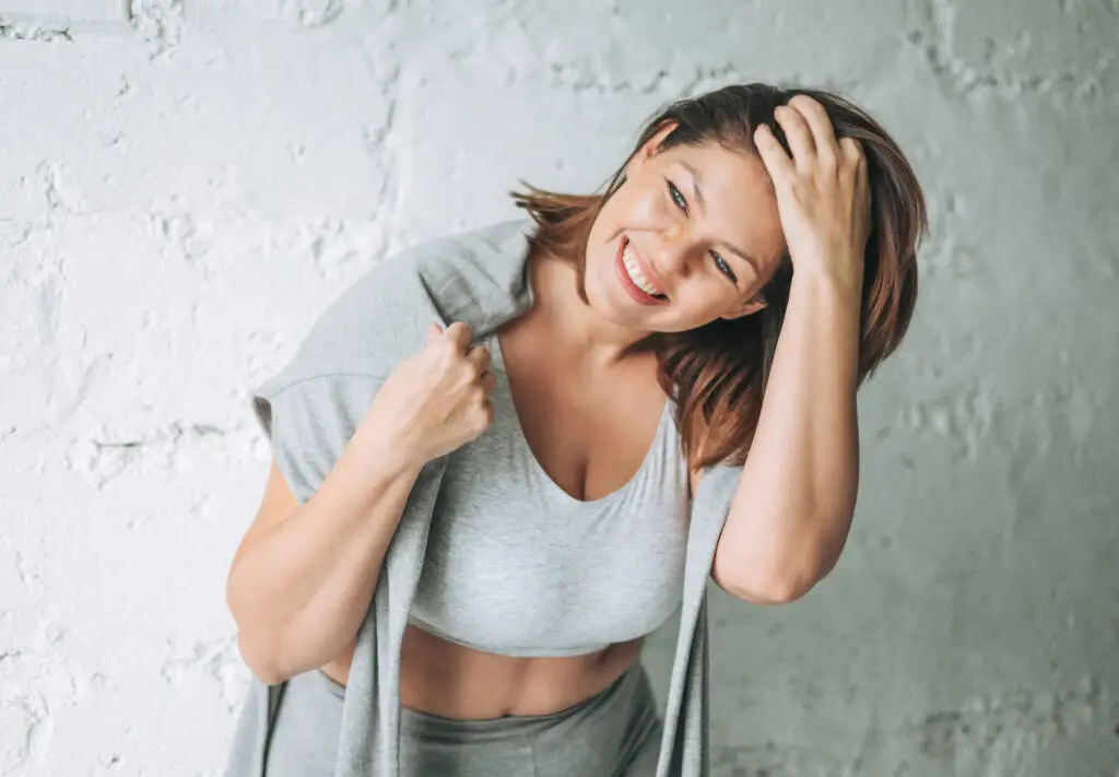 Beautiful happy emotional brunette young woman plus size body po